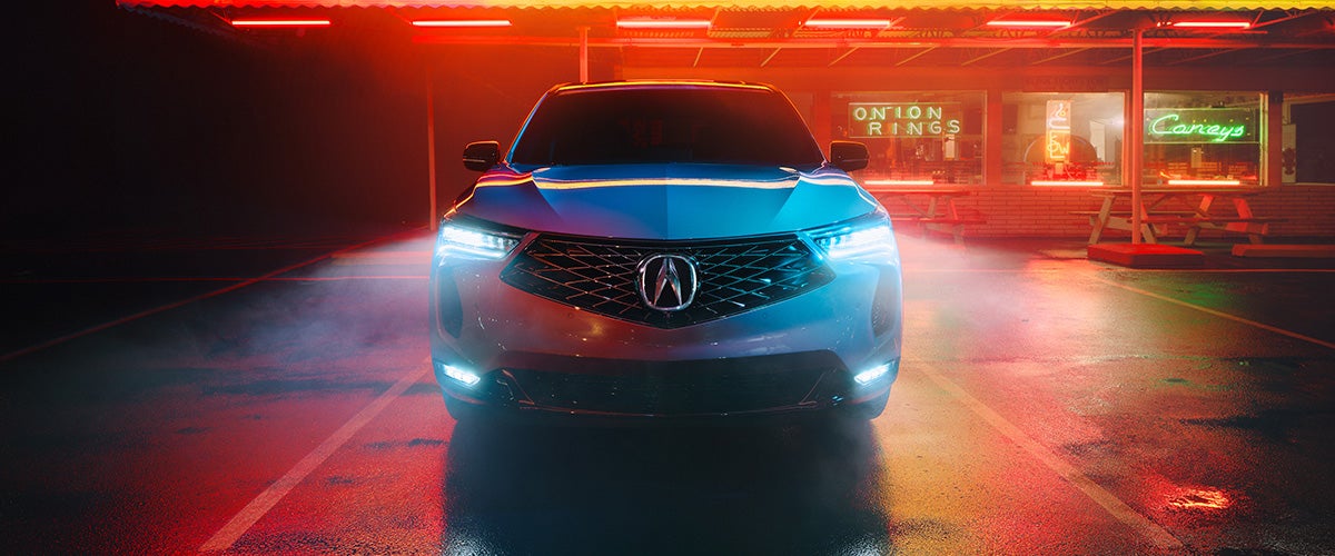Acura SUV in the parking lot at night